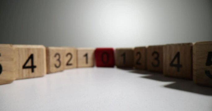 Wooden cubes with different numbers and red zero closeup. Learning logic and mathematical thinking