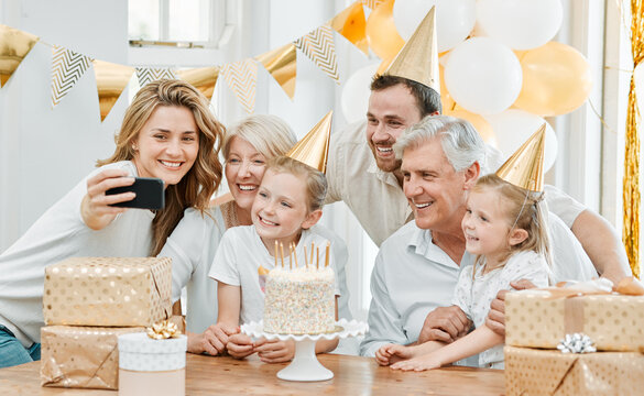 Being together is the best birthday gift ever. Shot of a happy family taking selfies while celebrating a birthday at home.