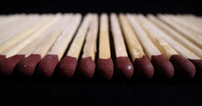Wooden matches with red heads on black background. Mortality from careless handling of fire