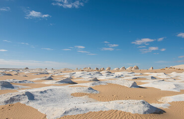 Barren white desert landscape in hot climate with rock formation