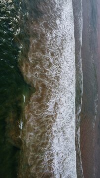 Arial drone view of ocen wave breaking into the sea beach HD