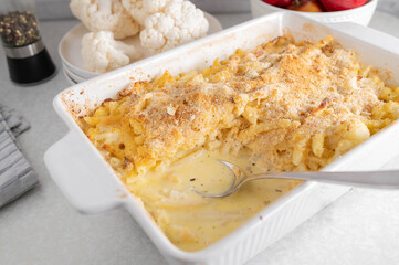 Pasta casserole with macaroni noodles, cauliflower, cheese sauce and bread crumb, parmesan cheese topping. Mac and cheese meal