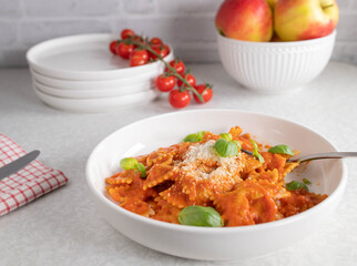Whole wheat pasta with tomato sauce and parmesan cheese on a plate