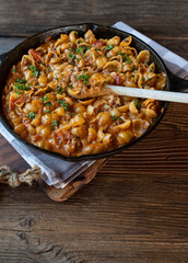 Creamy ground beef with pasta shells in a cast iron pan