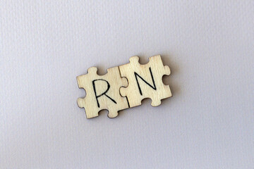 The acronym RN, which stands for Right Now. The letters written on the puzzles.