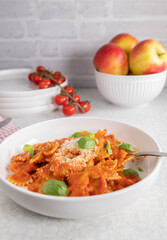 Whole grain noodles with homemade tomato sauce and parmesand cheese on a plate