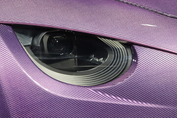 close up of clean purple carbon fiber exotic sports car headlight/ car wallpaper 