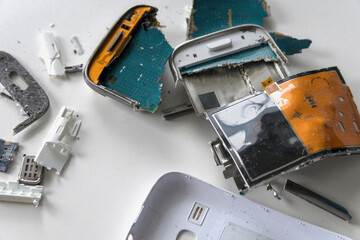 Insides of a dropped smartphone in a white case. close-up top view. Damage smartphone