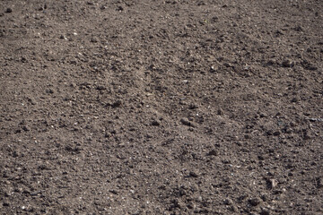 Black texture of the surface of the plowed and cultivated land