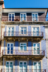 Facade of a Portuguese apartment building with blue tiles and balconies, Porto, Portugal, Europe