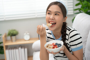 healthy food. Beautiful female girl enjoy eat yogurt, granola, fresh fruits on breakfast health in house. Happy young woman smile on morning good emotion. dieting, detox, diet, clean eat, vegetarian