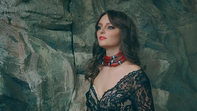Portrait Gothic fantasy woman fashion model posing. Red snake boa constrictor around neck girl princess strangles crushes. Aspred sinaloa. Lady vampire, black dress. Royal milk snake crawls on body