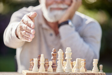 Good sportsmanship makes a good game. Shot of a senior man reaching to shake hands while playing a game of chess outside.