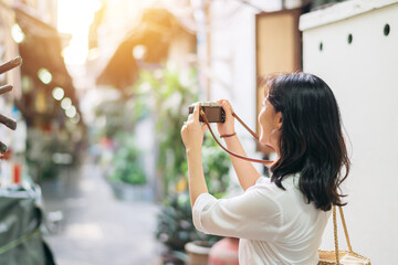 Happy youth asian woman person with camera travels street city trip on leisure weekend. Young...