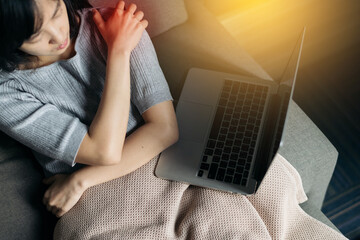 Naklejka premium Asian woman has shoulder pain. Female holding painful shoulder with another hand. People with body-muscles problem, Healthcare And Medicine.