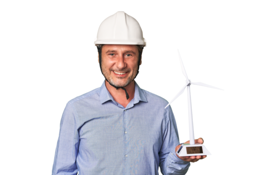 A middle-aged architect man holding a windmill model happy, smiling and cheerful.