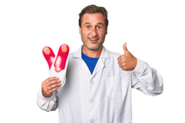 A middle-aged podiatrist holding an insoles
