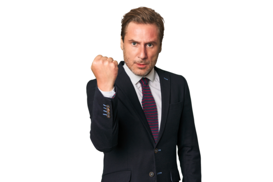 A middle-aged businessman isolated showing fist to camera, aggressive facial expression.