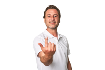 A middle-aged man isolated pointing with finger at you as if inviting come closer.