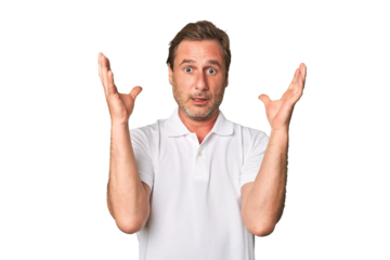 A middle-aged man isolated screaming to the sky, looking up, frustrated.