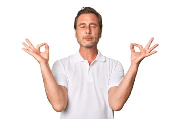 A middle-aged man isolated relaxes after hard working day, she is performing yoga.