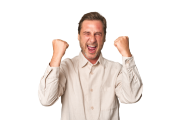 A middle-aged man isolated cheering carefree and excited. Victory concept.