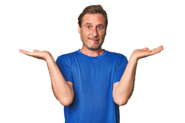 A middle-aged man isolated confused and doubtful shrugging shoulders to hold a copy space.