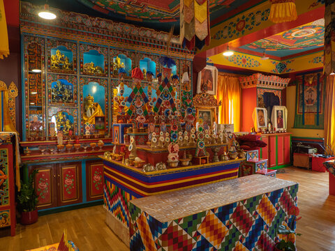 Panillo, Spain. February 27, 2022. Buddhist temple altar with offerings, symbols, Buddhas.