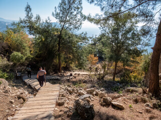 Tourists descend on a wooden deck in the ancient city of Syedra, Mediterranean coast, South Turkey