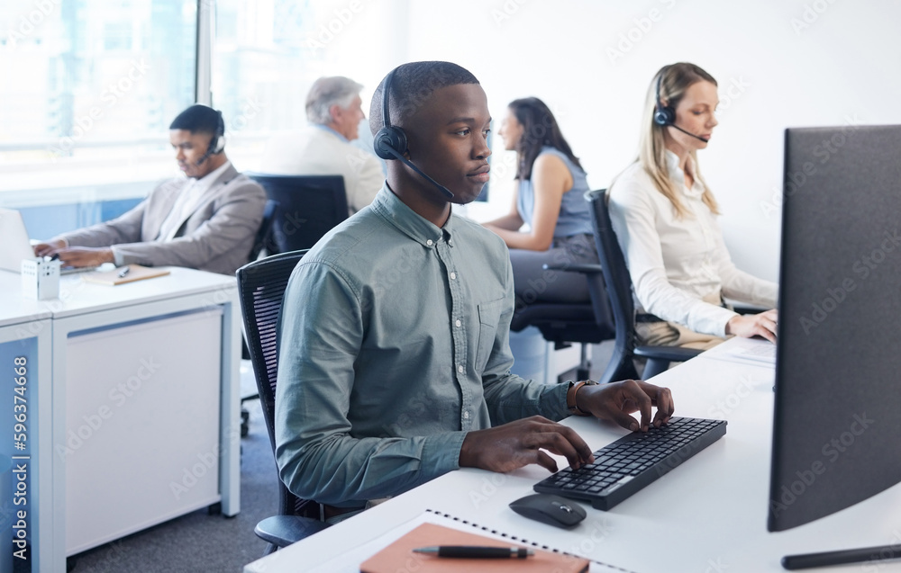 Aufkleber Here to help however possible. Shot of a young businessman using a headset and computer in a modern office.