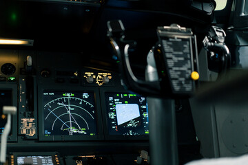 The interior of a modern airplane with a large instrument panel and navigation tools a close-up of the airplane's rudder