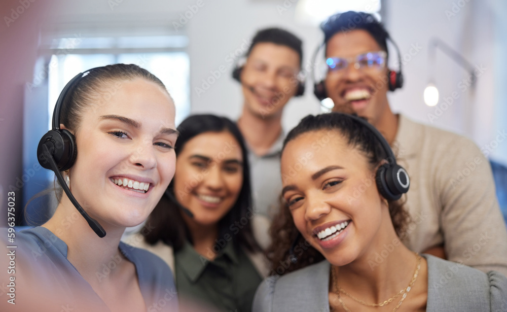 Poster were all eager to answer your calls. portrait of a group of call centre agents taking selfies in an 