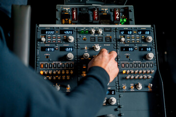 Fototapeta na wymiar The captain presses the buttons on the control panel to start the engine of the plane flight Up close flight simulator