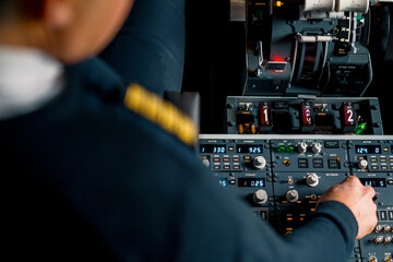 The captain presses the buttons on the control panel to start the engine of the plane flight Up close flight simulator