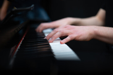Naklejka na ściany i meble hands of a person playing the piano