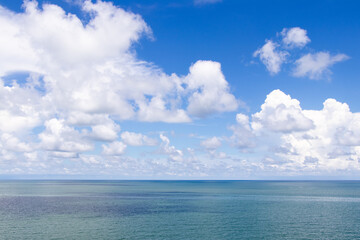 Naklejka na ściany i meble Beautiful calm turquoise color sea and blue sky with white color cloud background