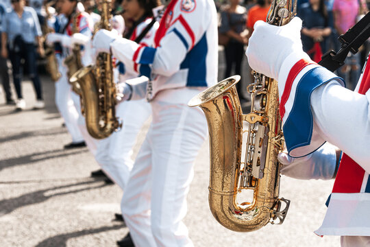Group of saxophonists playing a saxophone in a patriotic march