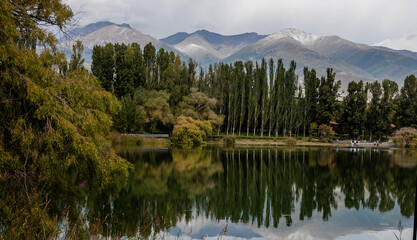 Snow-capped mountains and reflection of trees in the lake