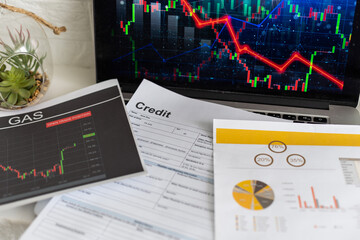 Global economic recession, stock market crash and inflation concept with digital falling down red candlestick and diagram on modern laptop keyboard background