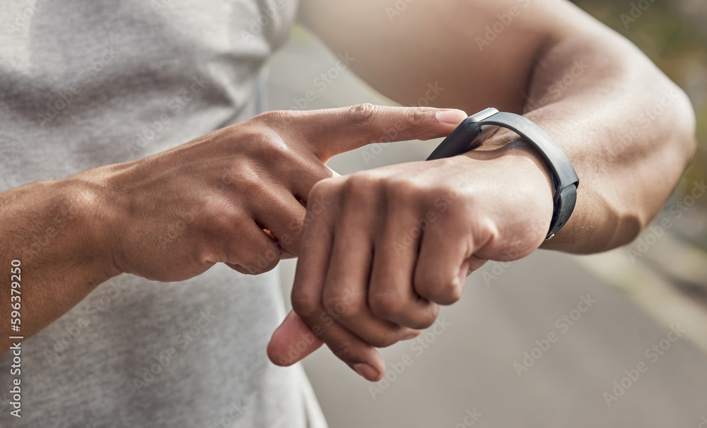 Poster whats your heart telling you. cropped shot of a man checking his watch while out for a run.