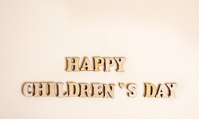 Fototapeta na wymiar happy childrens day inscription composed from wooden eco letters isolated on t shirt kid child sleeves.collar red as smile meaning joy of celebration. june 1st kids day