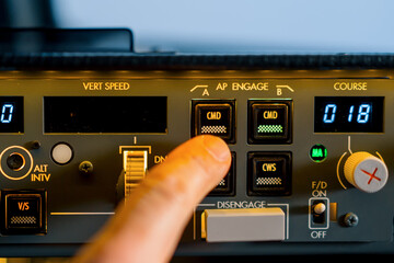 The pilot presses the power buttons on the control panel to control the aircraft in front of the...