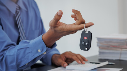 Real estate brokers are shaking hands to congratulate buyers after agreeing to insure and buy a...