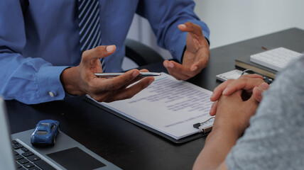 Real estate brokers are shaking hands to congratulate buyers after agreeing to insure and buy a...