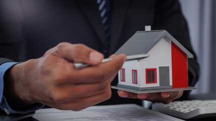 Real estate brokers are shaking hands to congratulate buyers after agreeing to insure and buy a house project. , Home Insurance Ideas home and land mortgage
