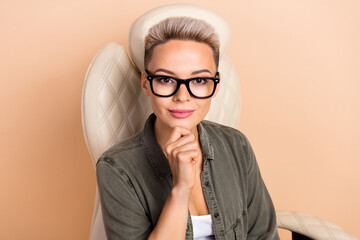 Photo of smart clever woman wear khaki shirt hand arm chin smiling isolated beige color background