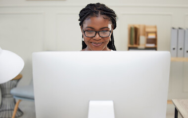 Getting things done today. Shot of a young businesswoman using a computer in an office at work.