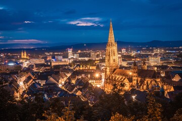 Blick auf die Stadt Freiburg (Deutschland) von oben bei Sonnenuntergang und aufziehendem Gewitter...