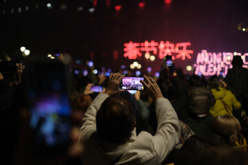Fototapeta na wymiar Mobile phone filming the Chinese New Year celebration in vertical mode 