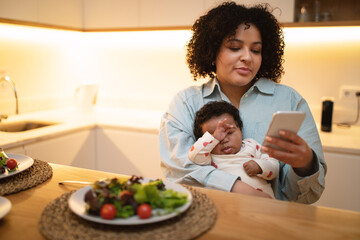 Beautiful woman mother have dinner with child on her lap - Powered by Adobe